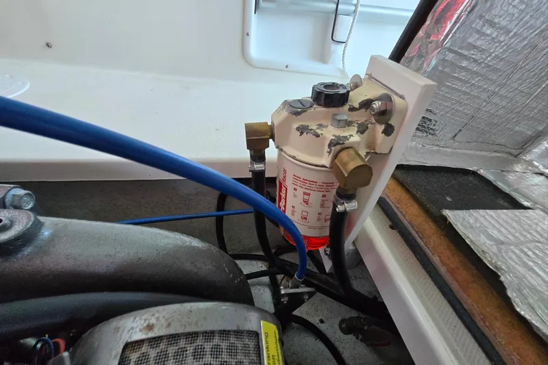 Slide: The Image of Engine compartment of a 2013 Atlas Boat Works Pompano 21, featuring a fuel filter system. - 29