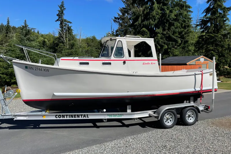 Slide: The Image of 2013 Atlas Boat Works Pompano 21 on trailer, parked outdoors with trees in background. - 3