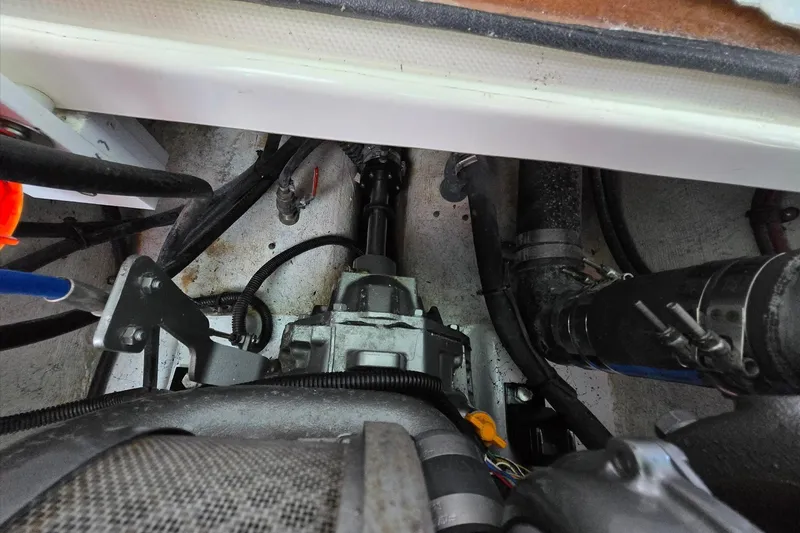 Slide: The Image of Engine compartment of a 2013 Atlas Boat Works Pompano 21, showing mechanical components and wiring. - 30