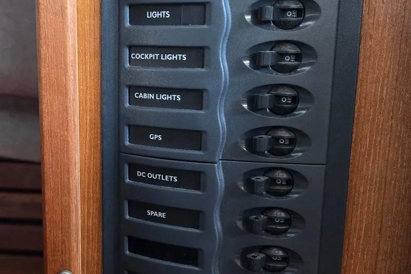 Slide: The Image of Control panel of a 2013 Atlas Boat Works Pompano 21 with labeled switches. - 31