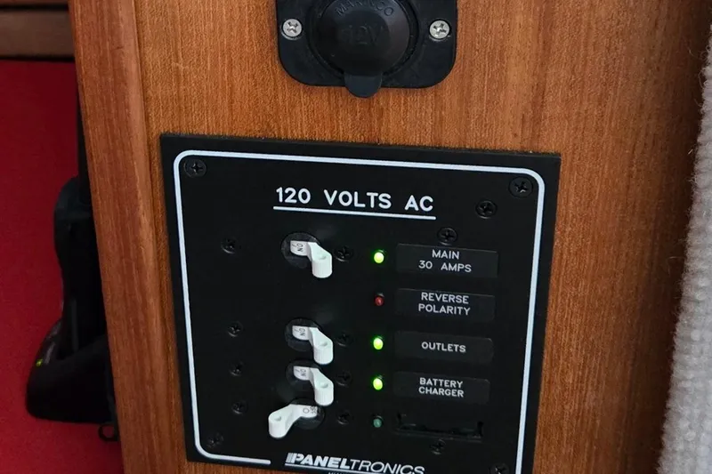 Slide: The Image of Electrical panel on 2013 Atlas Boat Works Pompano 21, showing 120 volts AC controls. - 32