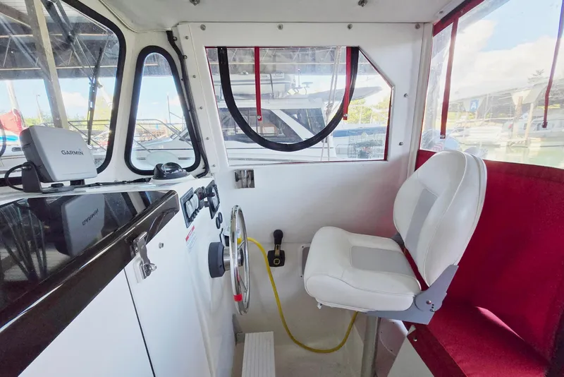 Slide: The Image of Interior of 2013 Atlas Boat Works Pompano 21, featuring helm and seating area. - 34