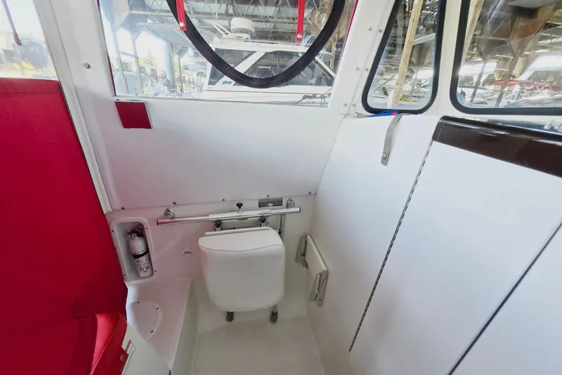 Slide: The Image of Interior of 2013 Atlas Boat Works Pompano 21, featuring a compact marine toilet. - 36