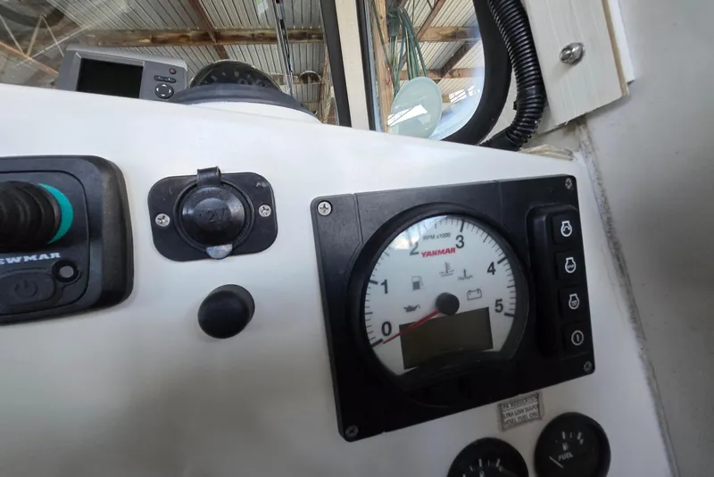 Slide: The Image of Control panel of a 2013 Atlas Boat Works Pompano 21, featuring Yanmar RPM gauge. - 40