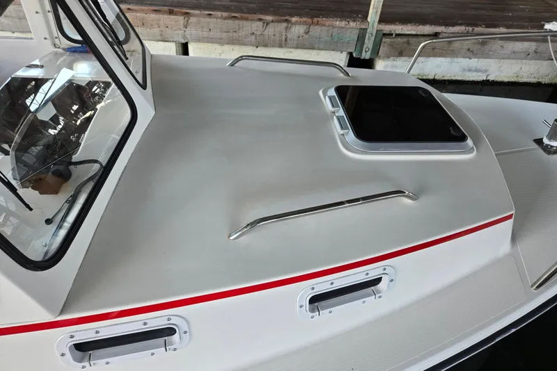 Slide: The Image of 2013 Atlas Boat Works Pompano 21 deck with hatch and windshield detail. - 6