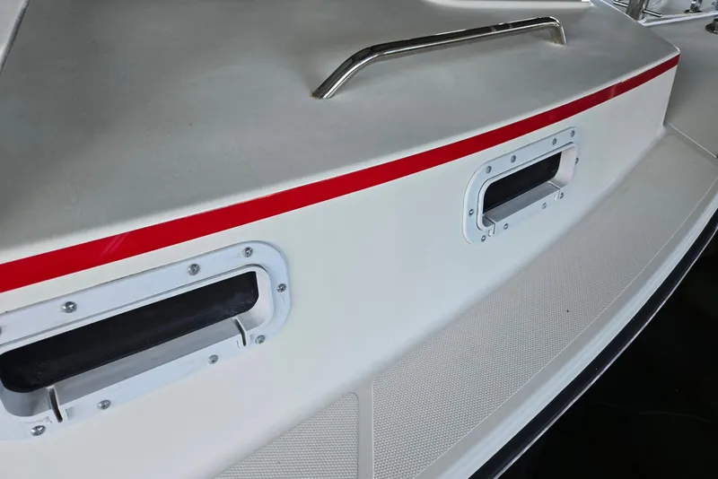 Slide: The Image of 2013 Atlas Boat Works Pompano 21 deck with red stripe and metal handle. - 7