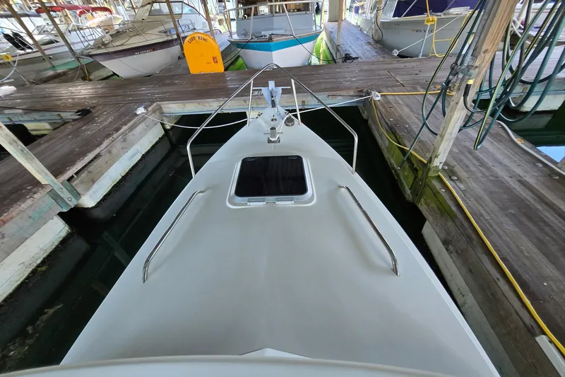 Slide: The Image of 2013 Atlas Boat Works Pompano 21 docked, showcasing bow and deck details. - 8