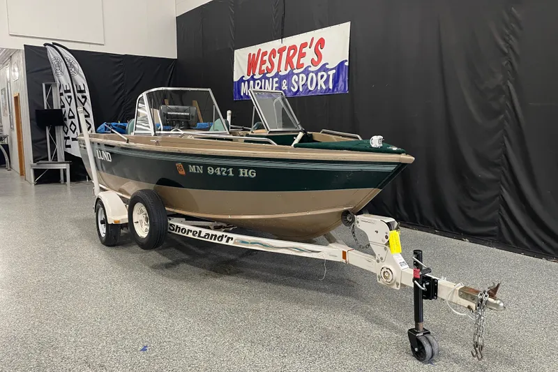 The Image of 1997 Lund 1700 Pro Sport boat on ShoreLand'r trailer in showroom. - 1