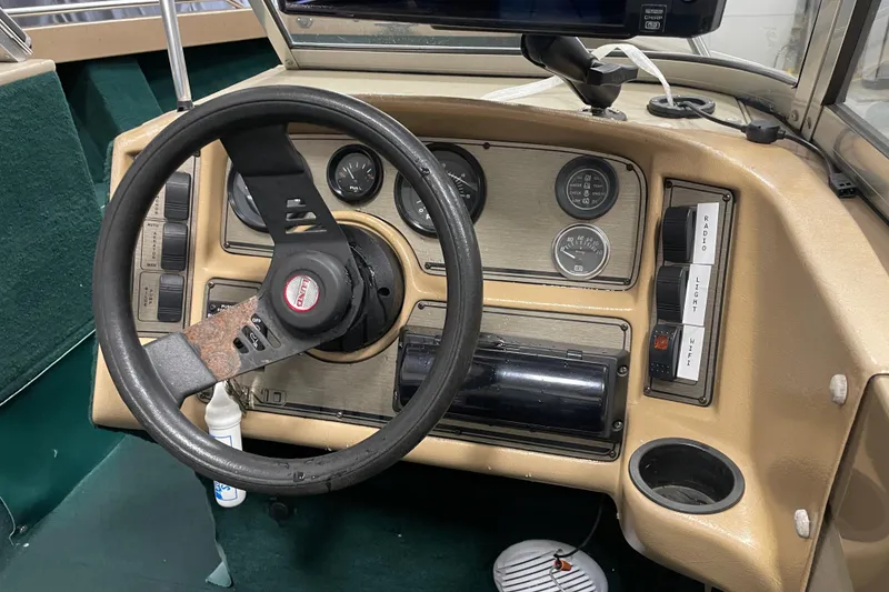 Slide: The Image of 1997 Lund 1700 Pro Sport dashboard with steering wheel and control panel. - 12