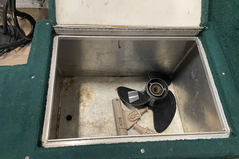 Slide: The Image of Open storage compartment in 1997 Lund 1700 Pro Sport boat with propeller inside. - 15