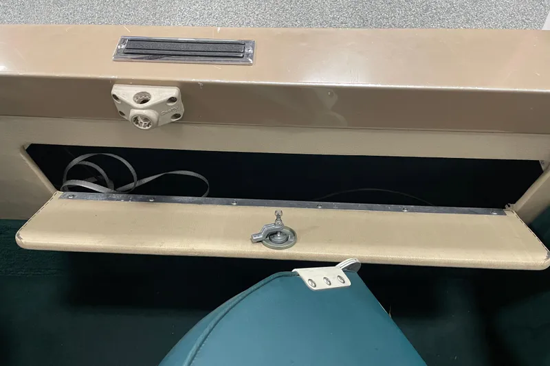 Slide: The Image of 1997 Lund 1700 Pro Sport boat interior storage compartment with open lid and visible wiring. - 16