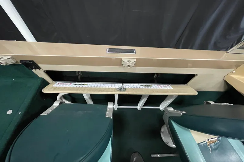 Slide: The Image of 1997 Lund 1700 Pro Sport interior with measuring board and green seating. - 17