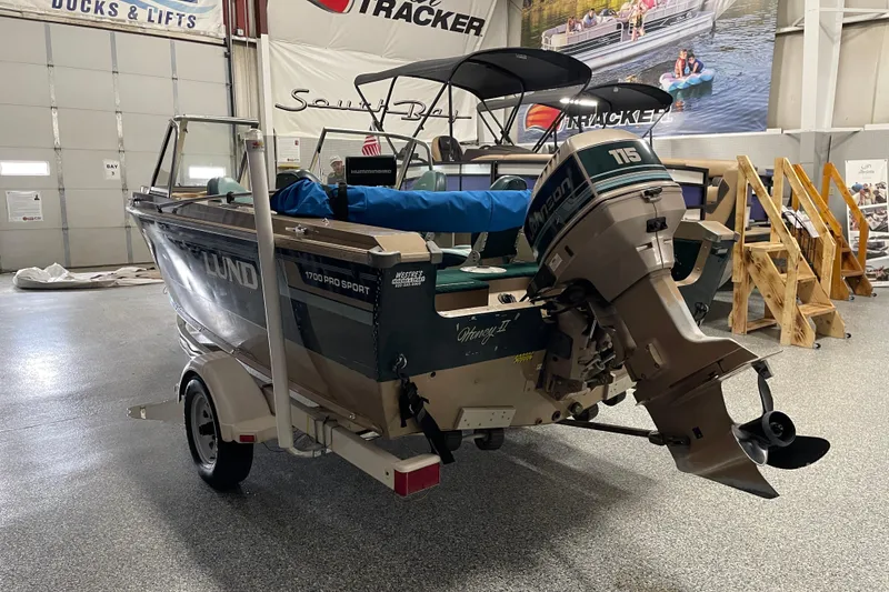 Slide: The Image of 1997 Lund 1700 Pro Sport boat with Johnson 115 outboard motor in showroom. - 4
