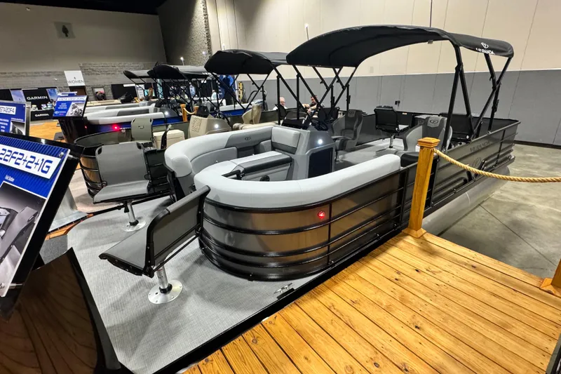 Slide: The Image of 2026 Veranda Vista 22F2+2 pontoon boat displayed indoors with seating and canopy. - 1