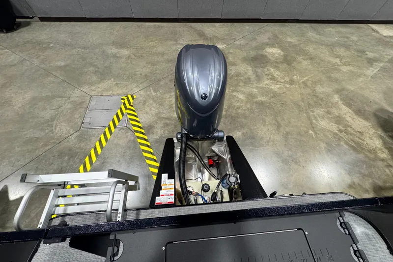 Slide: The Image of Top view of 2026 Veranda Vista 22F2+2 boat engine and ladder on concrete floor. - 10