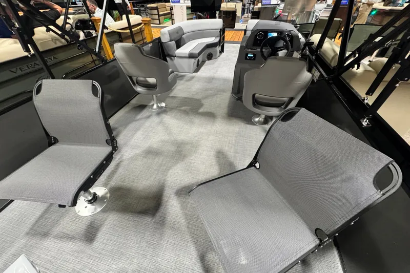 Slide: The Image of 2026 Veranda Vista 22F2+2 boat interior with modern seating and steering console. - 11