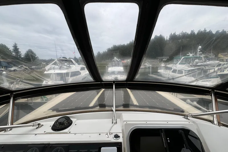 Slide: The Image of 1989 Bayliner 4588 Pilothouse Motor Yacht cockpit view in marina setting. - 14