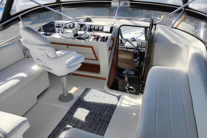 Slide: The Image of 1989 Bayliner 4588 Pilothouse interior with helm, seating, and navigation equipment. - 16