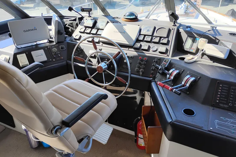 Slide: The Image of Cockpit of 1989 Bayliner 4588 Pilothouse with steering wheel and navigation equipment. - 17