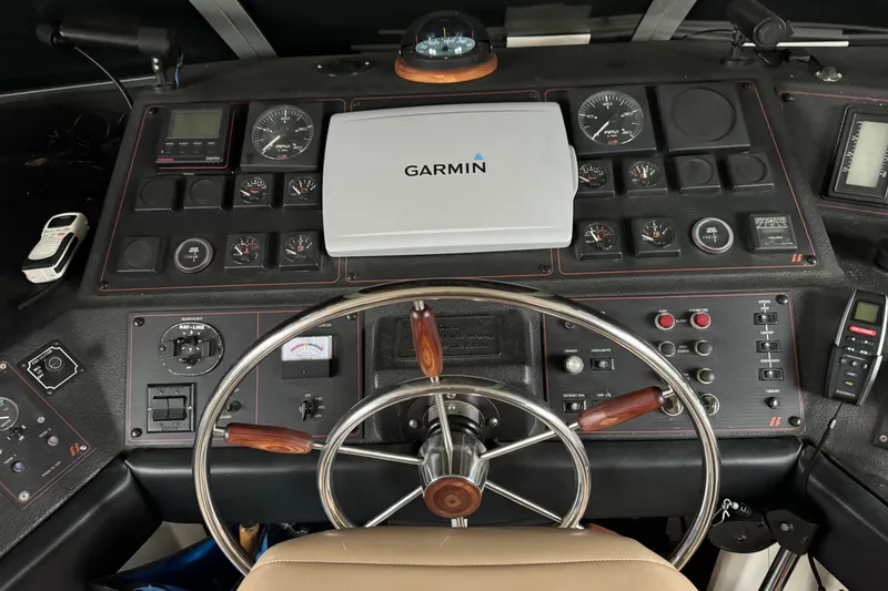 Slide: The Image of 1989 Bayliner 4588 Pilothouse Motor Yacht helm with Garmin navigation system and control panel. - 18