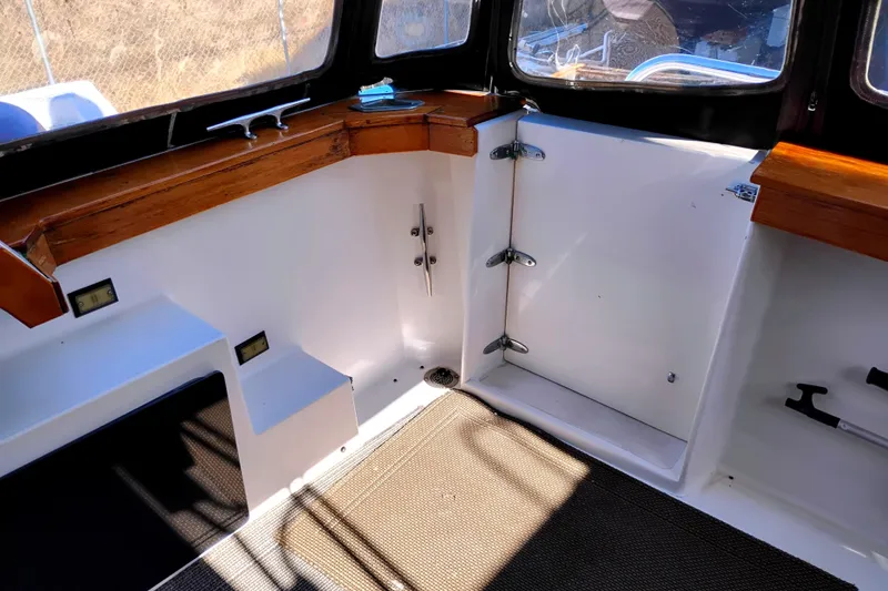 Slide: The Image of 1989 Bayliner 4588 Pilothouse interior with wood accents and carpeted flooring. - 2
