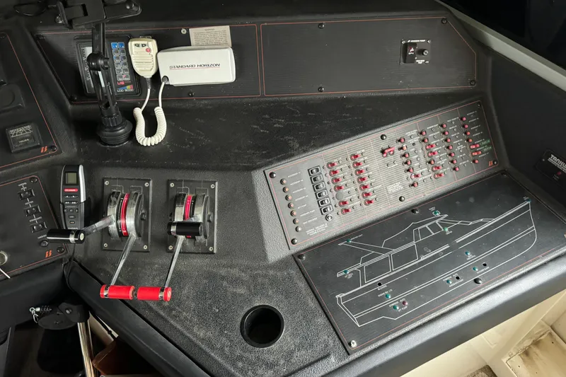 Slide: The Image of Control panel of a 1989 Bayliner 4588 Pilothouse Motor Yacht with levers and switches. - 20