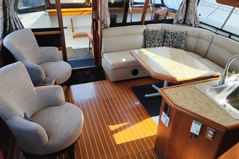 Slide: The Image of Luxurious interior of 1989 Bayliner 4588 Pilothouse with seating, table, and kitchenette. - 25