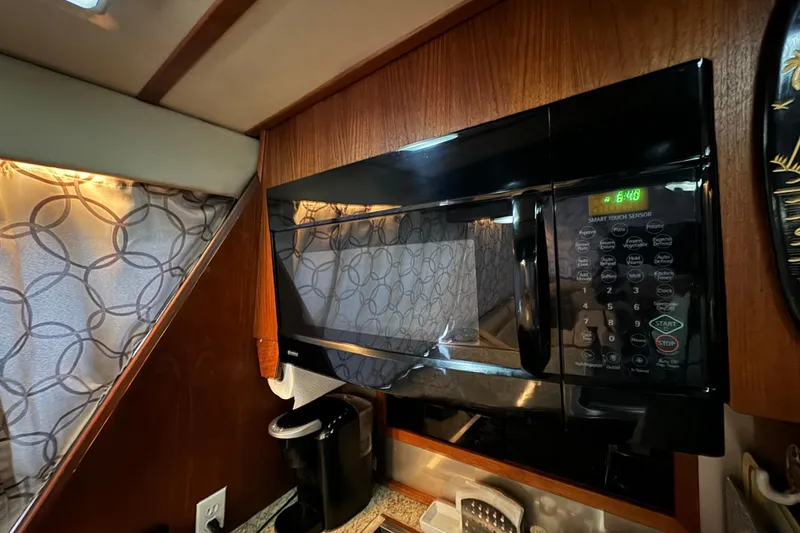 Slide: The Image of Microwave in 1989 Bayliner 4588 Pilothouse Motor Yacht kitchen with patterned curtains. - 34