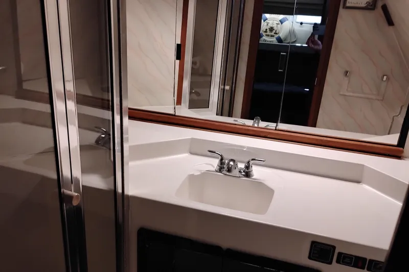 Slide: The Image of Bathroom sink area in 1989 Bayliner 4588 Pilothouse yacht with mirrored cabinet. - 39