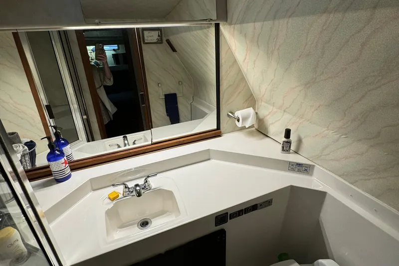 Slide: The Image of Bathroom interior of 1989 Bayliner 4588 Pilothouse Motor Yacht with sink and mirror. - 40