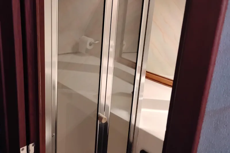 Slide: The Image of 1989 Bayliner 4588 Pilothouse bathroom with mirrored door and toilet paper holder. - 41