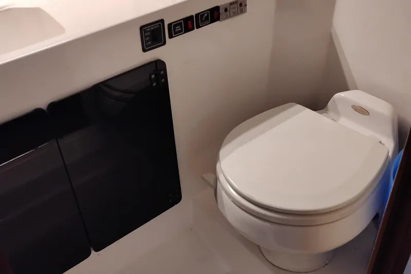 Slide: The Image of 1989 Bayliner 4588 Pilothouse bathroom with modern marine toilet and control panel. - 42