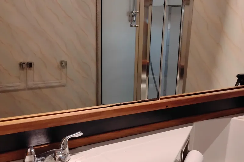 Slide: The Image of Bathroom interior of 1989 Bayliner 4588 Pilothouse with mirror and faucet. - 48