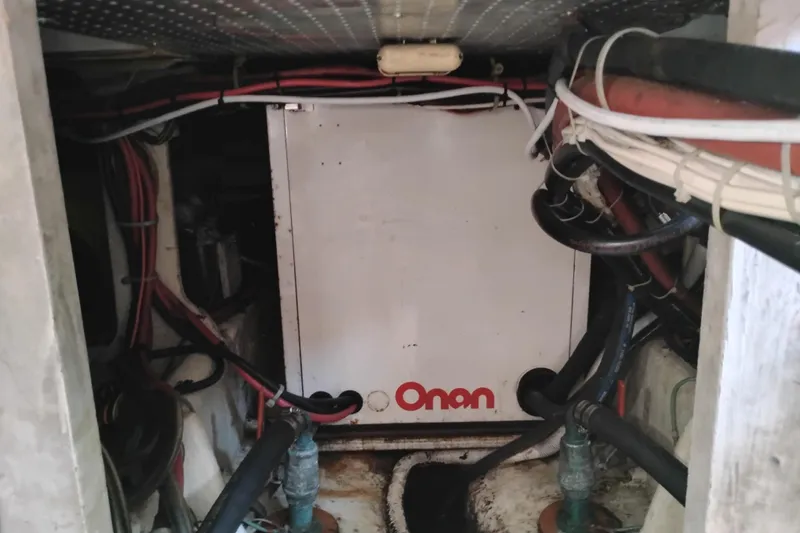 Slide: The Image of Engine room of 1989 Bayliner 4588 Pilothouse with Onan generator and wiring. - 54