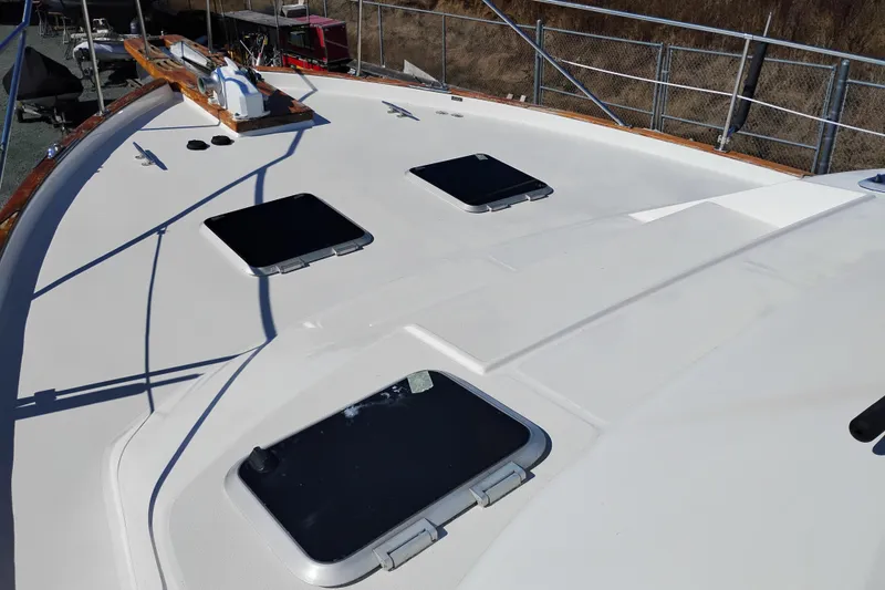 Slide: The Image of 1989 Bayliner 4588 Pilothouse deck with hatches and railing in a boatyard. - 55
