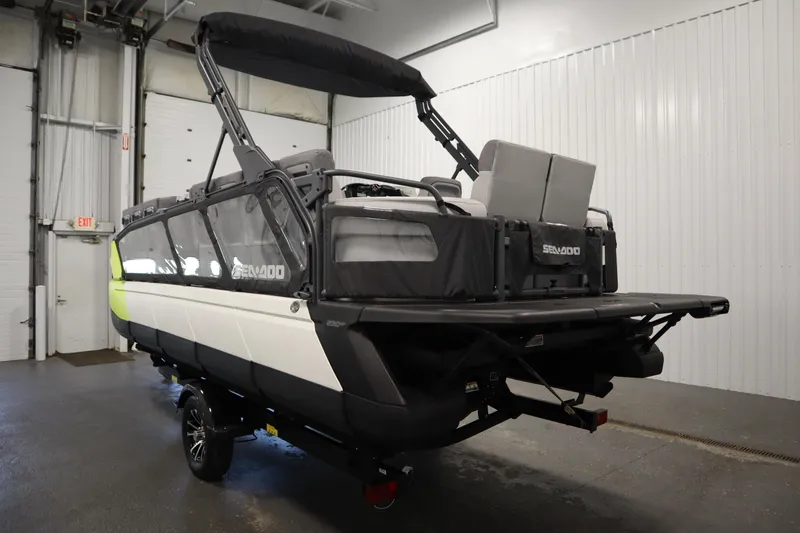 Slide: The Image of 2024 Sea-Doo Switch Sport/Cruise 21, 230 hp, spacious interior, modern design, in a garage setting. - 13