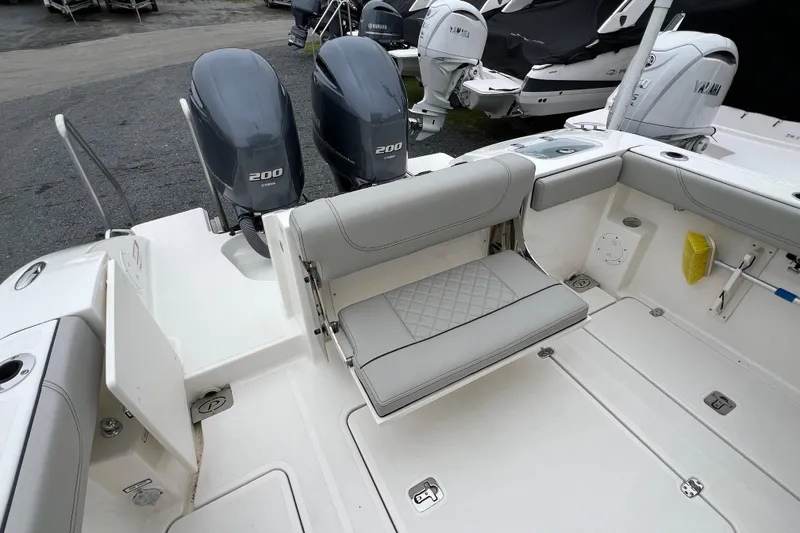 Slide: The Image of 2023 Pursuit S 268 Sport boat with dual Yamaha 200 engines and spacious seating area. - 13