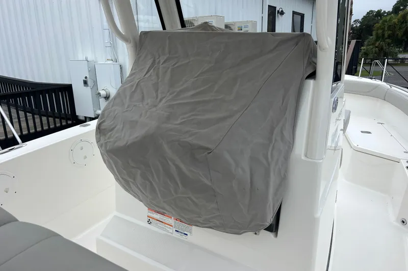 Slide: The Image of 2023 Pursuit S 268 Sport boat with covered console, docked outdoors. - 18