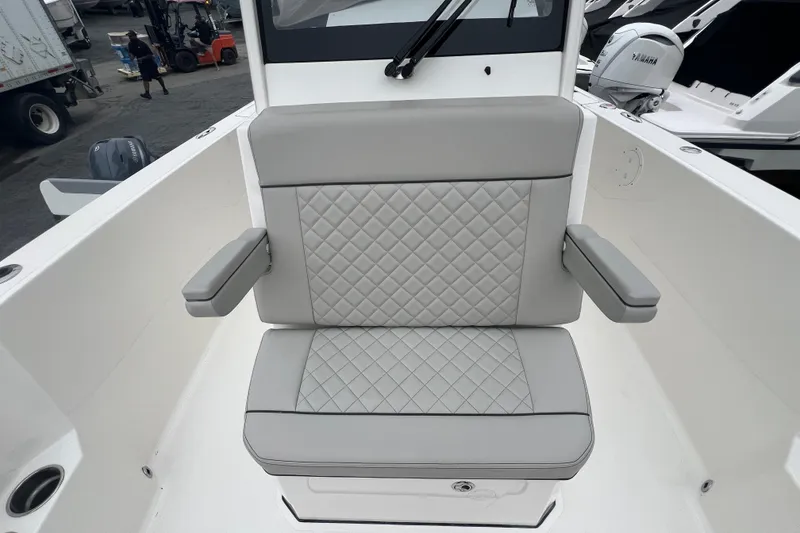 Slide: The Image of 2023 Pursuit S 268 Sport boat seat with quilted gray upholstery and armrests. - 19