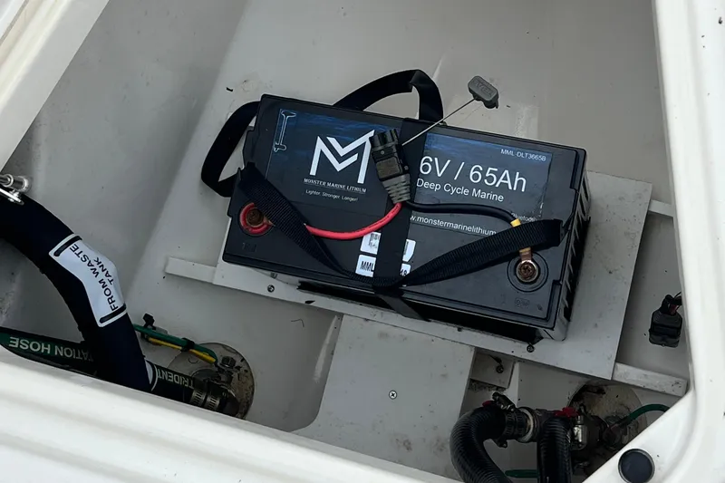 Slide: The Image of Marine battery in 2023 Pursuit S 268 Sport boat, 6V 65Ah deep cycle, secured with straps. - 22
