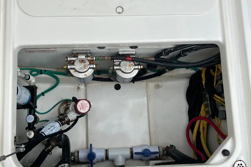 Slide: The Image of 2023 Pursuit S 268 Sport boat engine compartment with wiring and components. - 25