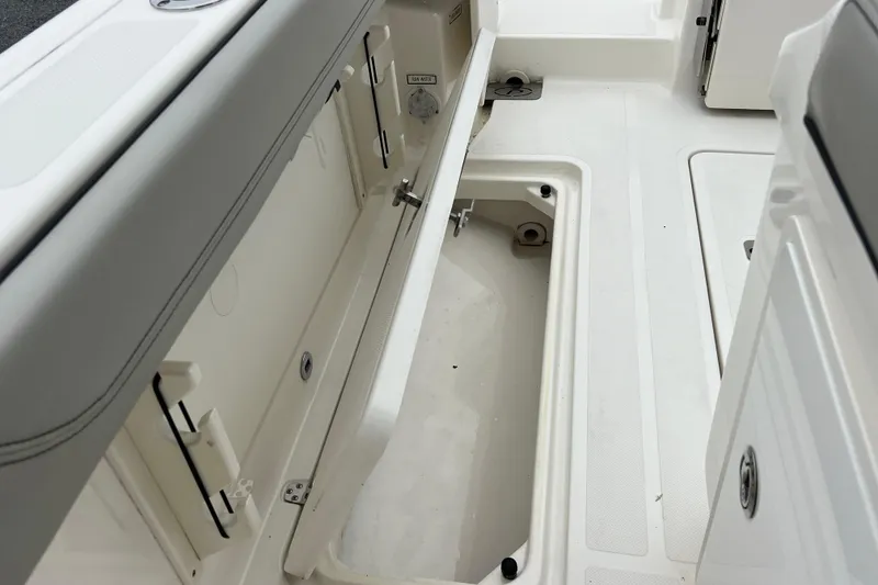 Slide: The Image of 2023 Pursuit S 268 Sport boat interior storage compartment, open and empty. - 27