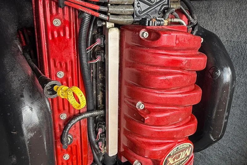 Slide: The Image of 2006 MasterCraft X45 engine with red components and visible wiring. - 13