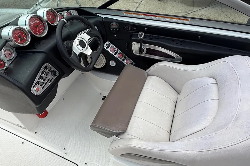 Slide: The Image of 2006 MasterCraft X45 boat interior with steering wheel, gauges, and plush captain's seat. - 15