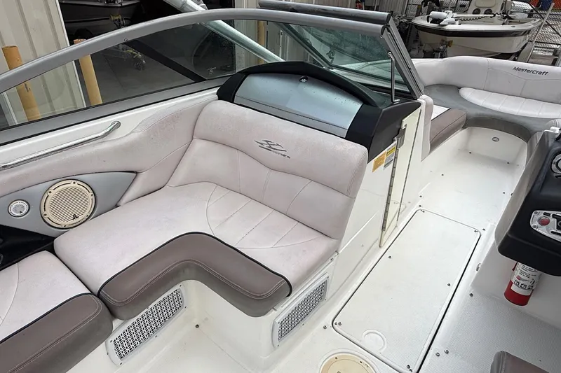 Slide: The Image of 2006 MasterCraft X45 boat interior with cushioned seating and control panel. - 19