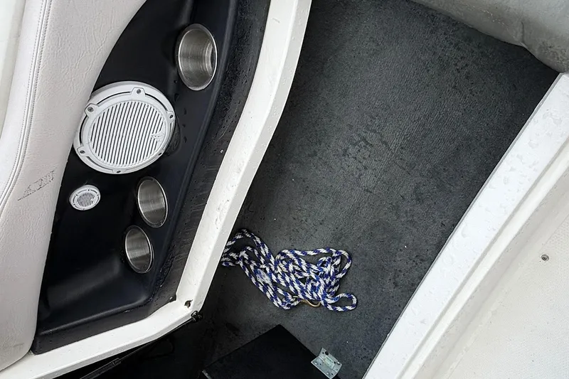 Slide: The Image of 2006 MasterCraft X45 interior with speaker, cup holders, and rope on carpeted floor. - 21
