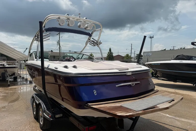 Slide: The Image of 2006 MasterCraft X45 boat on trailer under cloudy sky. - 3