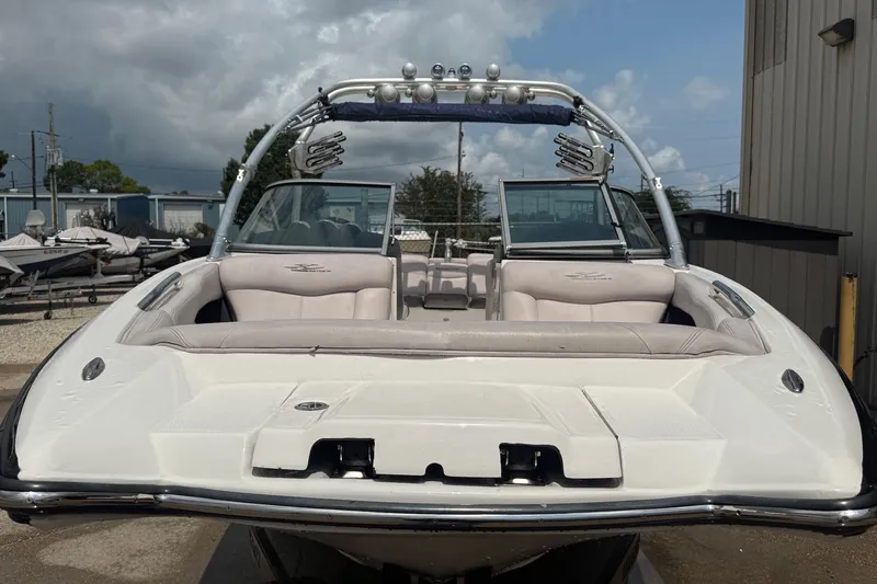 Slide: The Image of 2006 MasterCraft X45 boat with sleek design and spacious seating, parked outdoors. - 6