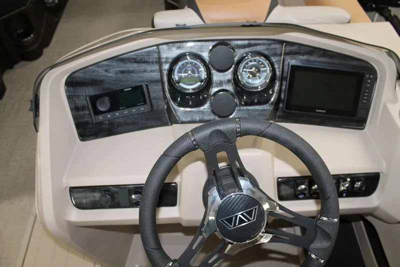 Slide: The Image of Steering console of 2025 Avalon LSZ Quad Lounger 23 FT with modern gauges and controls. - 12