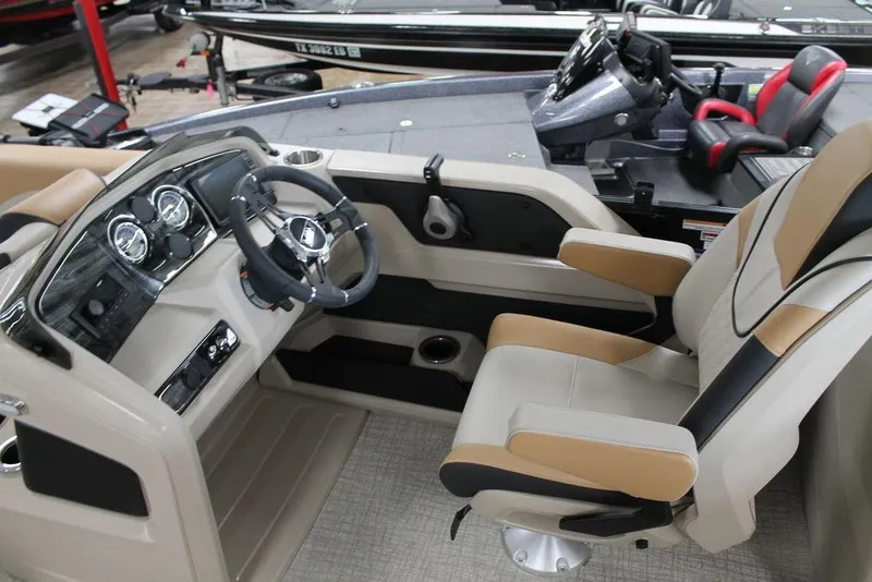 Slide: The Image of 2025 Avalon LSZ Quad Lounger 23 FT boat interior with modern steering and seating. - 7